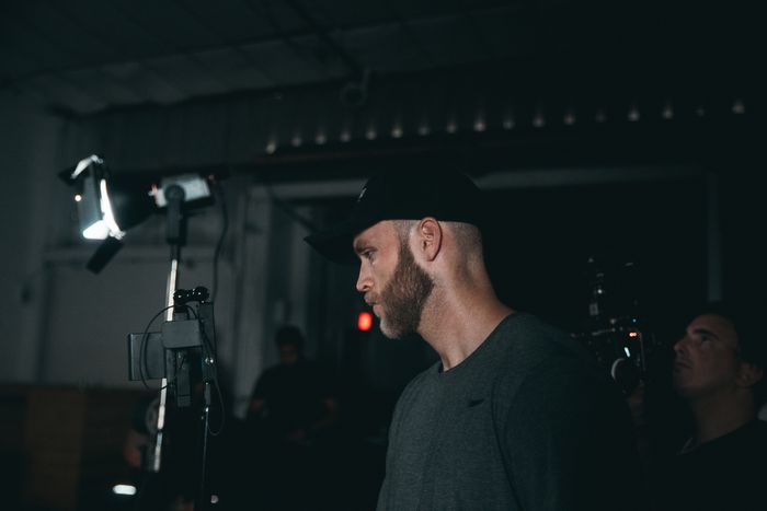 Camera operator working on a lit film set — photo by Kyle Loftus on Pexels