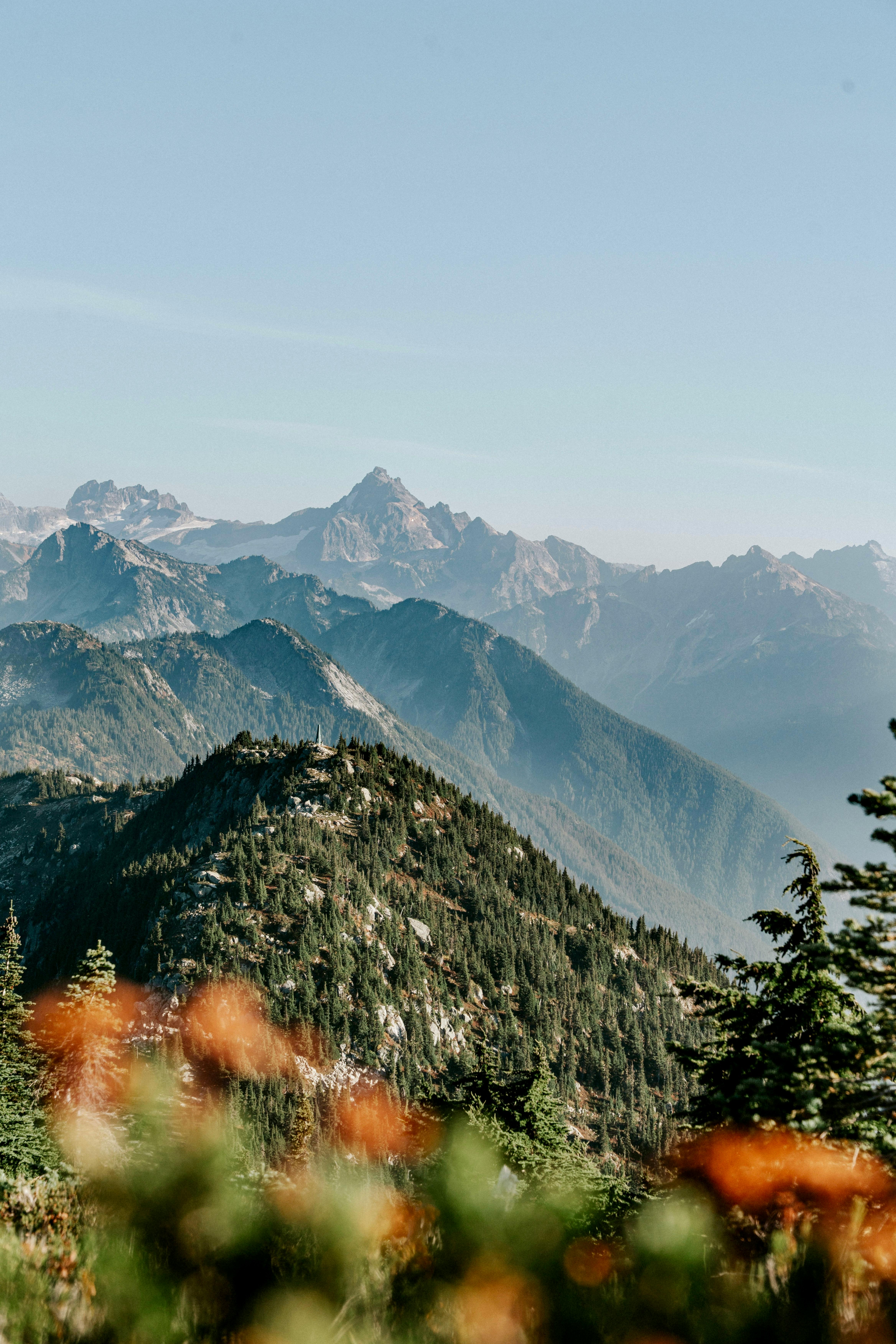 Breathtaking mountain range view with vibrant greenery under clear skies.