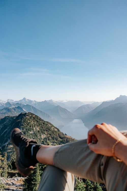 Free A hiker enjoys a breathtaking view of a mountainous landscape on a clear day. Stock Photo