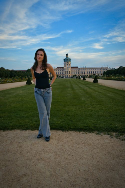 Free A woman poses in front of Charlottenburg Palace, Berlin, on a sunny day. Stock Photo