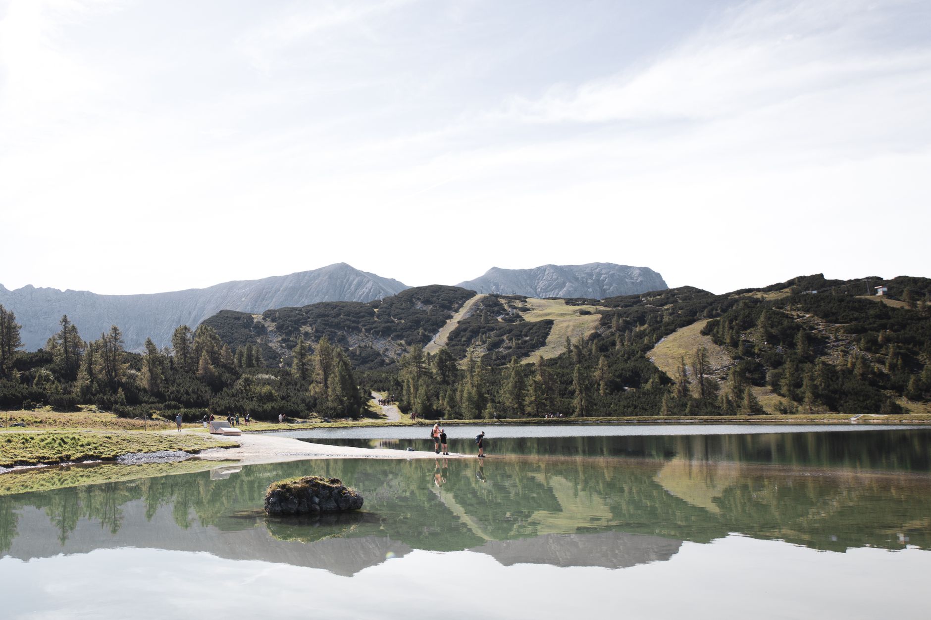 Explore the mesmerizing landscape of Hinterstoder, Austria, with serene lake reflection and majestic mountains.