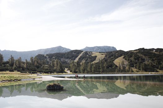 Explore the mesmerizing landscape of Hinterstoder, Austria, with serene lake reflection and majestic mountains.