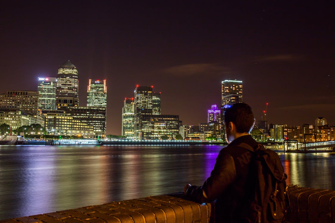 Free Man in Black Jacket Looking at the City Stock Photo