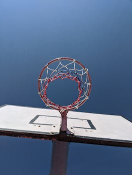 Low angle view of a basketball hoop and backboard against a clear blue sky in Thimphu, Bhutan.