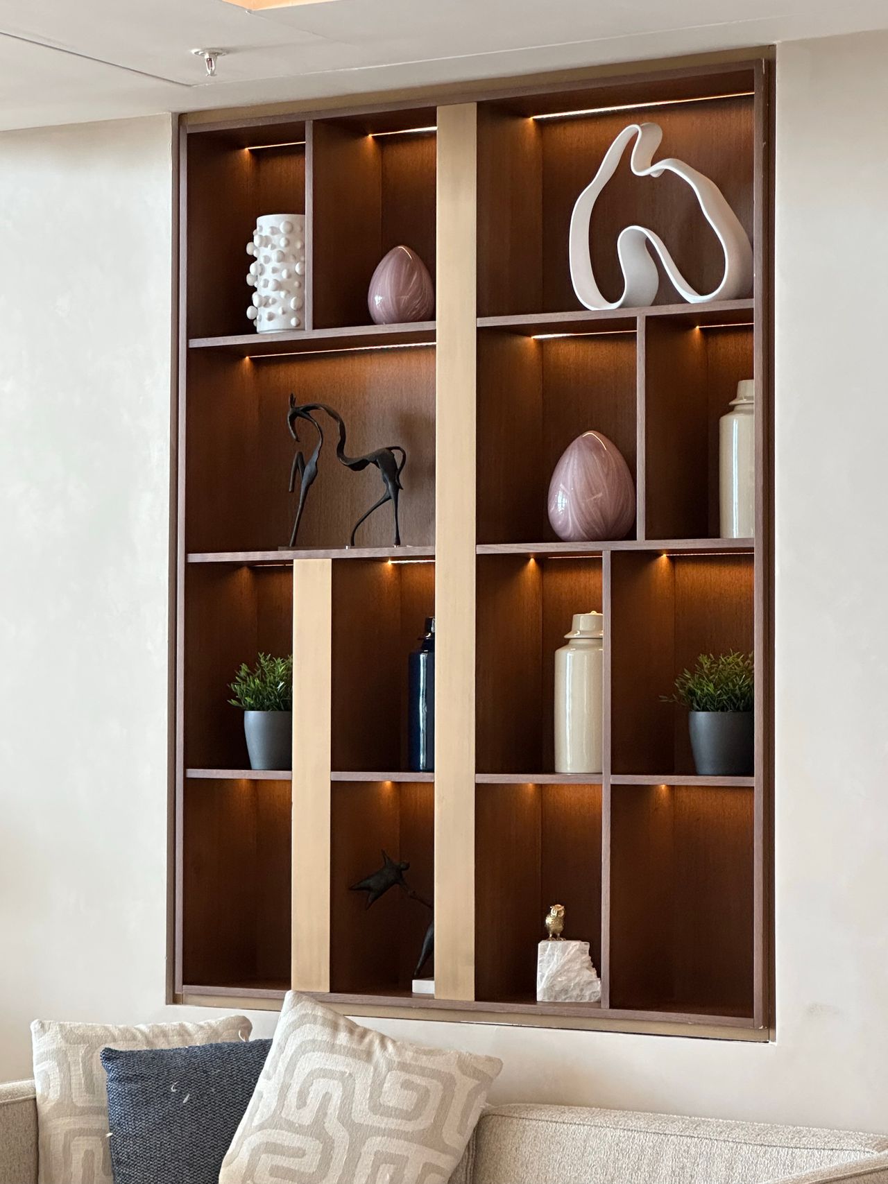 floating-shelves-living-room Elegant wall shelves styled with vases, books and decor in a modern living room