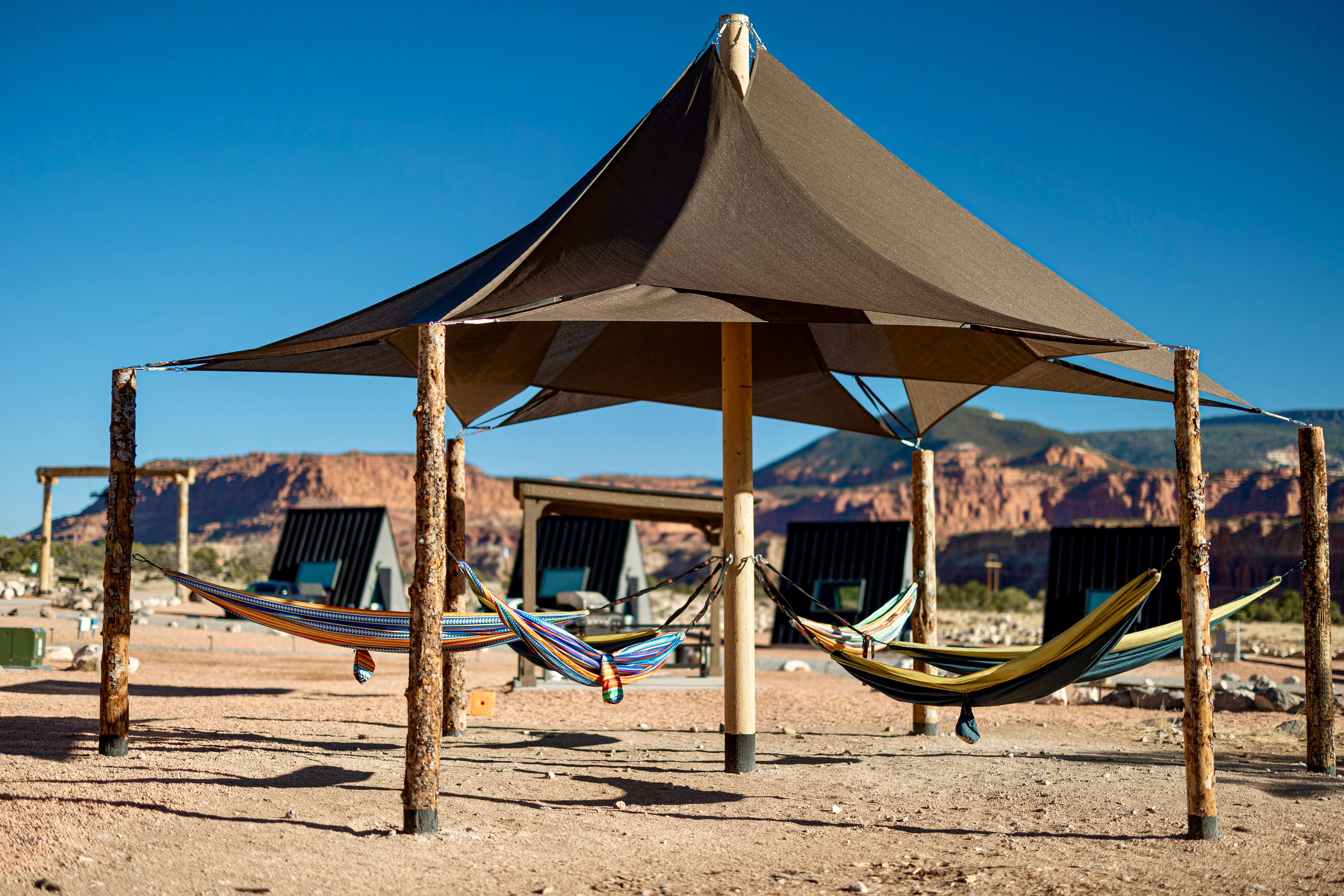 canvas hammock strung between posts in a desert backyard