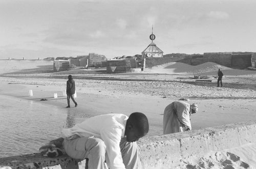 Free People exploring a beach with unique architectural structures in South Africa. Stock Photo