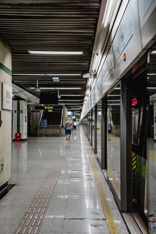 Free Spacious interior of a Shanghai metro station platform during the day with few pedestrians. Stock Photo