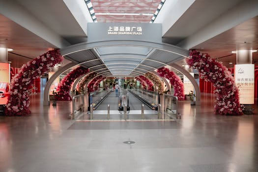 A modern interior view of a Shanghai airport terminal featuring vibrant floral decorations.