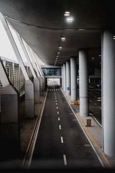 Empty road in a modern Shanghai airport terminal showcasing sleek architectural design.