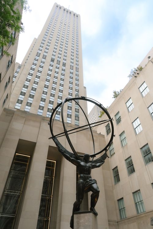 Free Iconic Atlas statue at Rockefeller Center with skyscraper background in NYC. Stock Photo