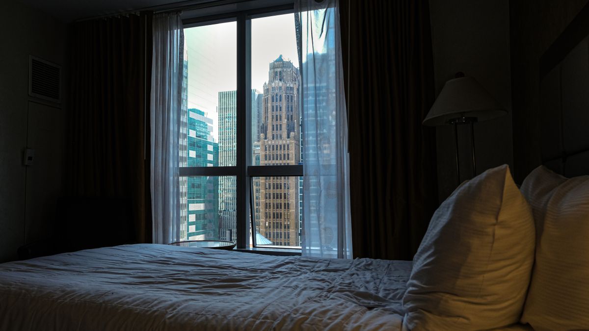 City view from a cozy hotel room in New York City, offering an urban skyline perspective.
