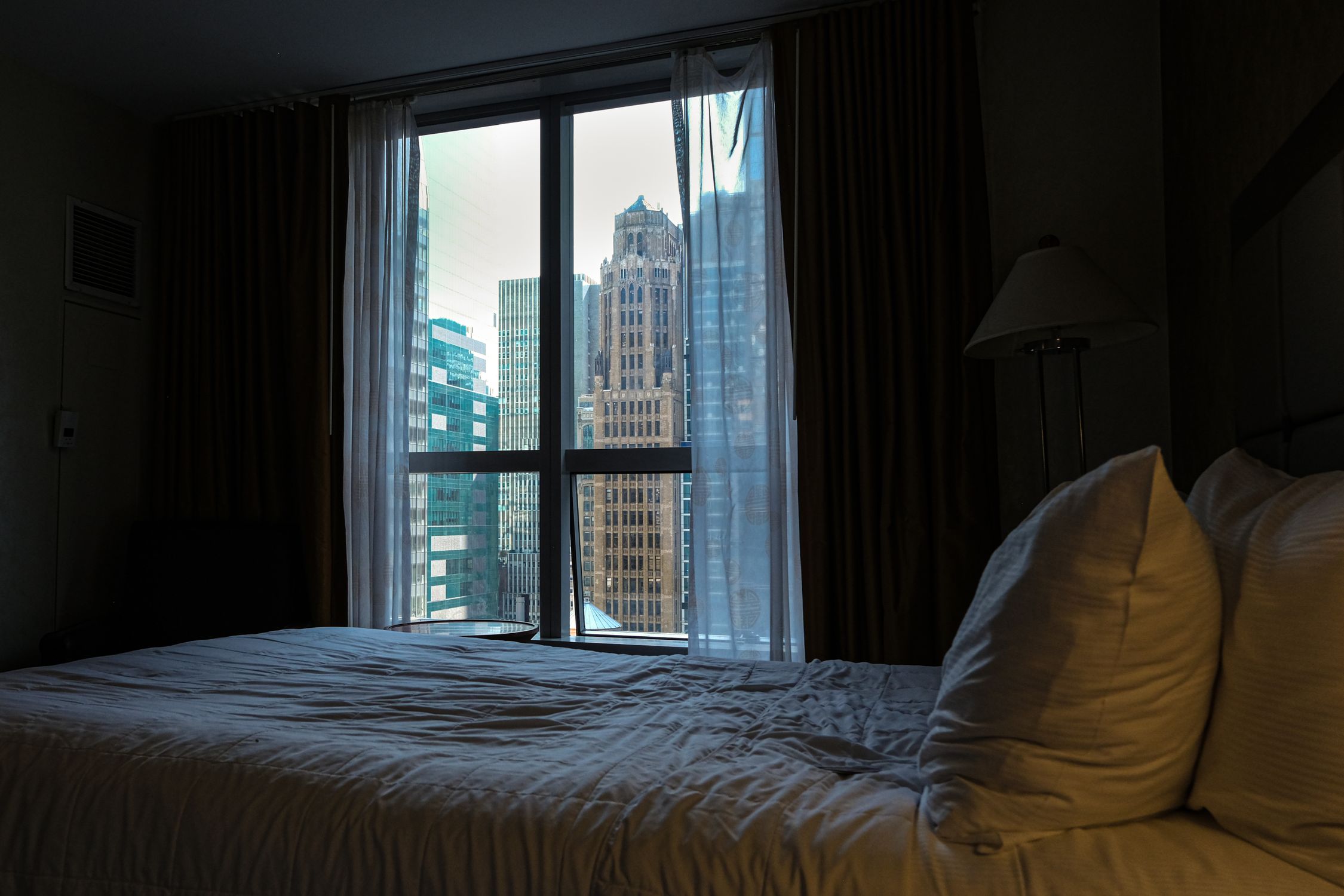 City view from a cozy hotel room in New York City, offering an urban skyline perspective.