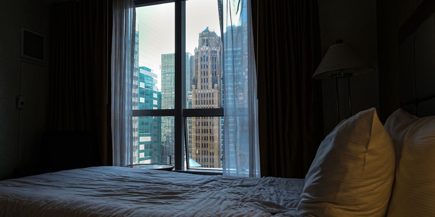 View of a city skyline through the window of a hotel room