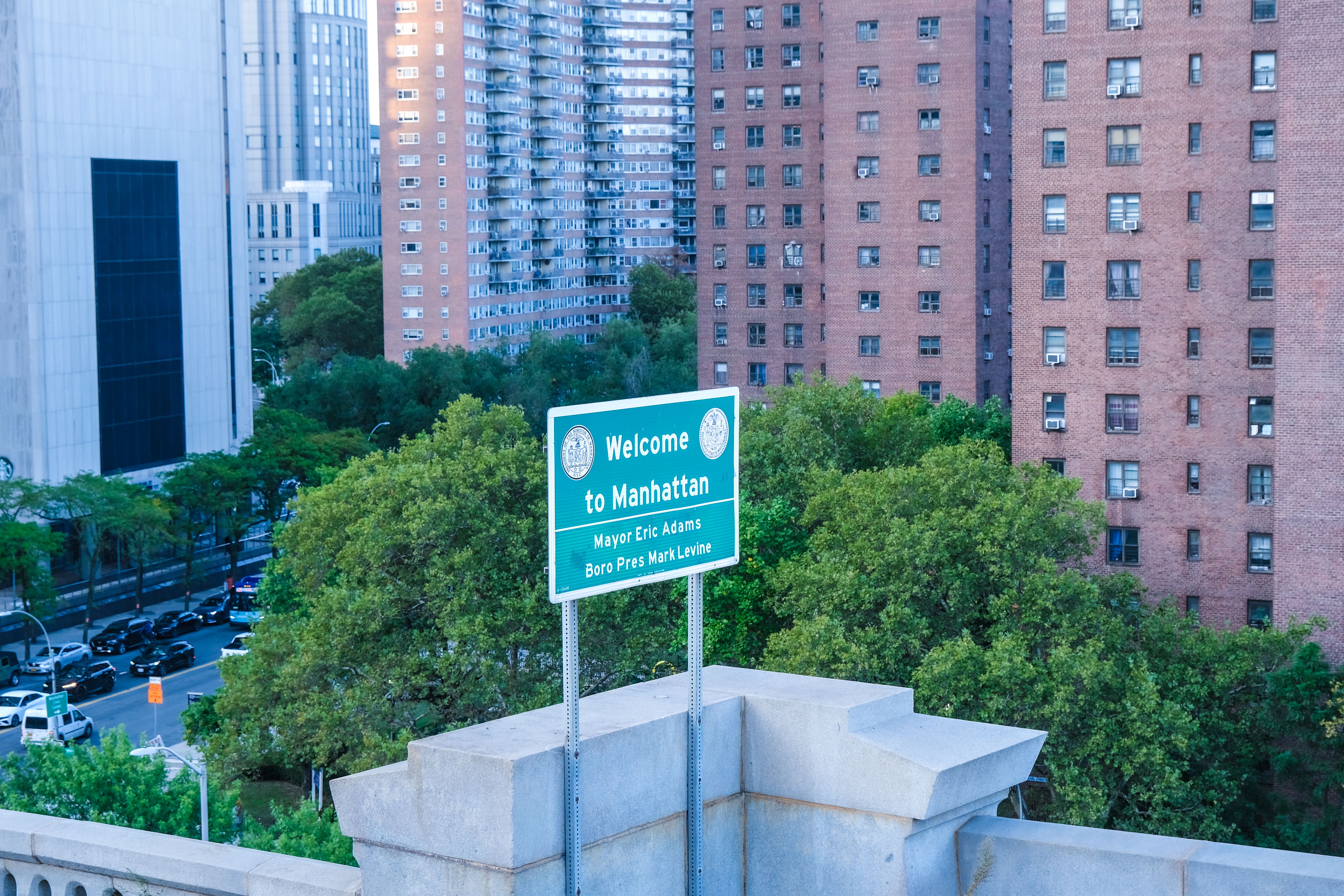Overview of Manhattan with a welcome sign and urban architecture in New York City.