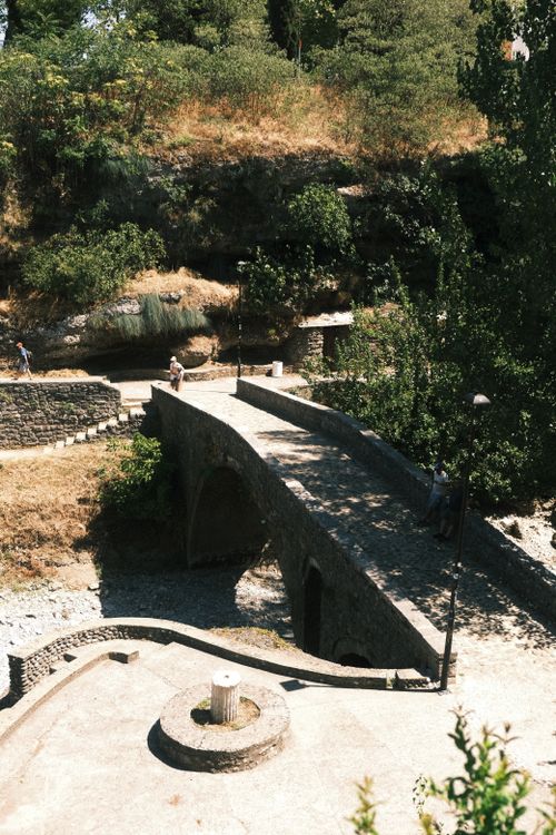 Free Explore the historic charm of an ancient stone bridge in Podgorica, Montenegro, surrounded by lush greenery. Stock Photo