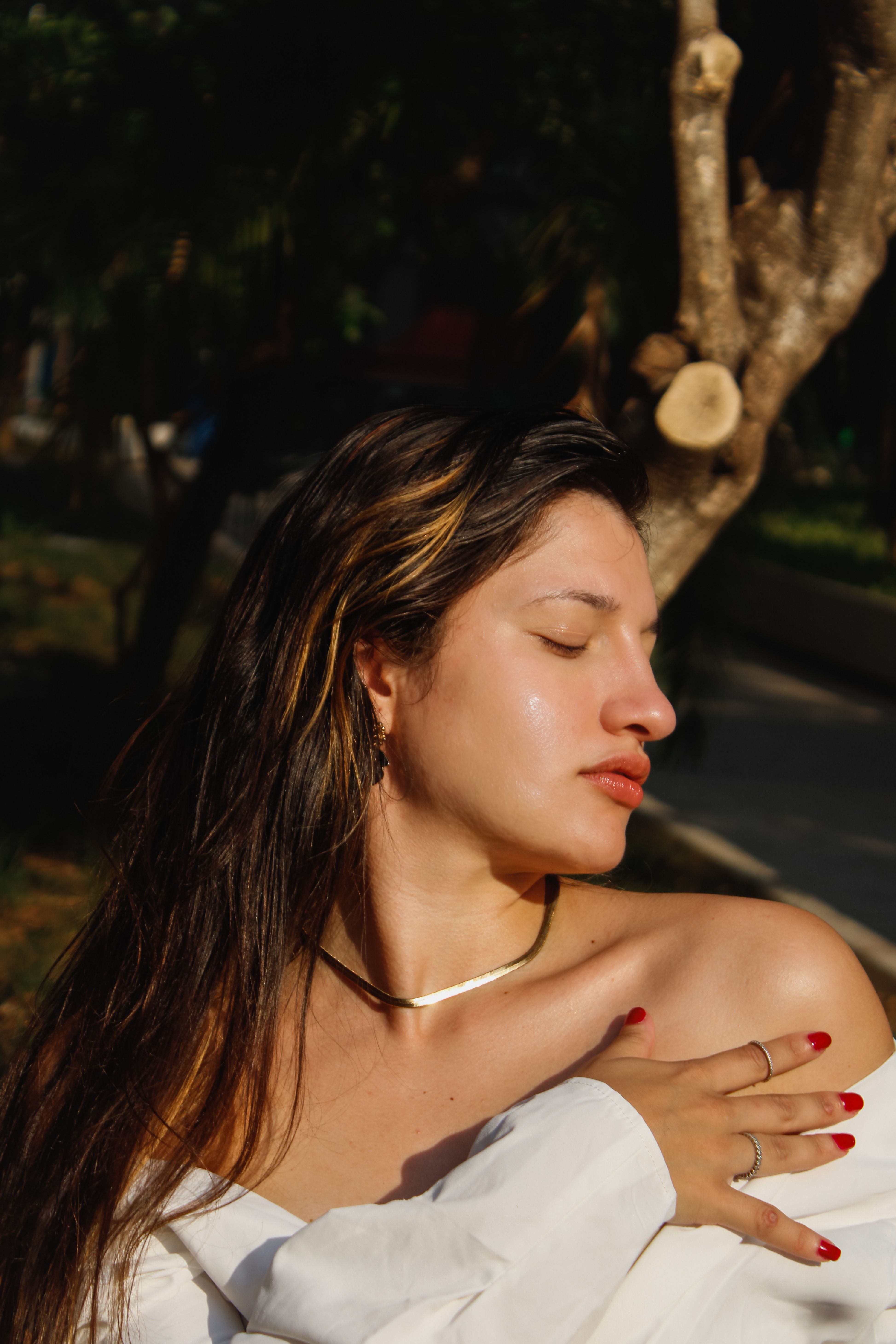 Tranquil Outdoor Portrait of a Woman in Sunlight · Free Stock Photo