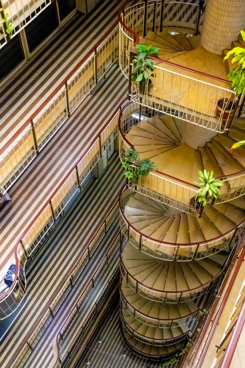 Free Aerial view of a spiral staircase in an Istanbul building, featuring lush indoor plants. Stock Photo