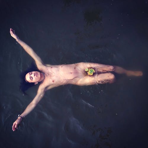 Free Nude Man Lying on Water Stock Photo
