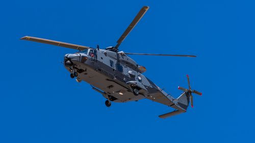 Free NH90 helicopter flying against a clear blue sky in Castilla-La Mancha, Spain. Stock Photo