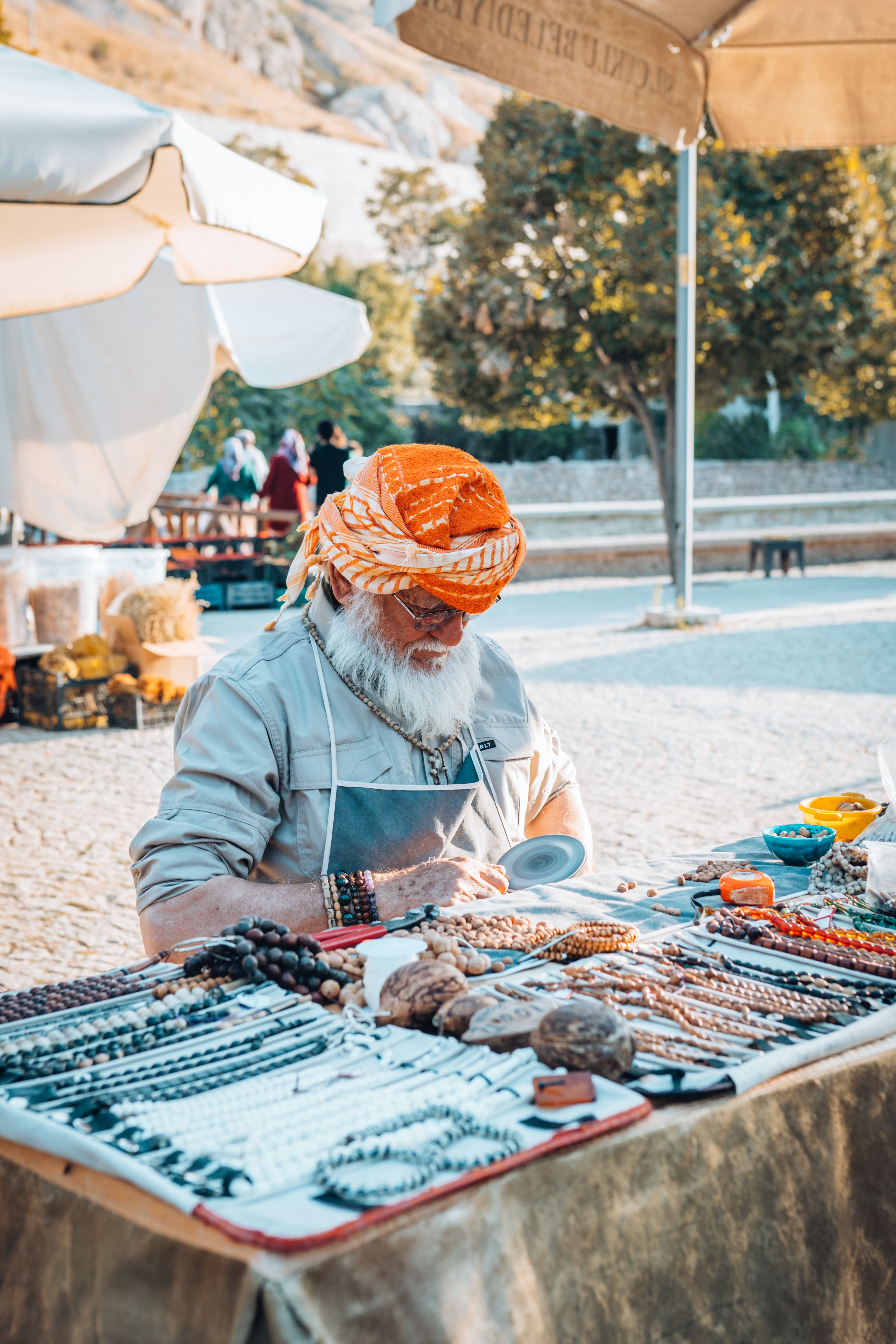 Colorful Outdoor Market Stall with Vendor · Free Stock Photo