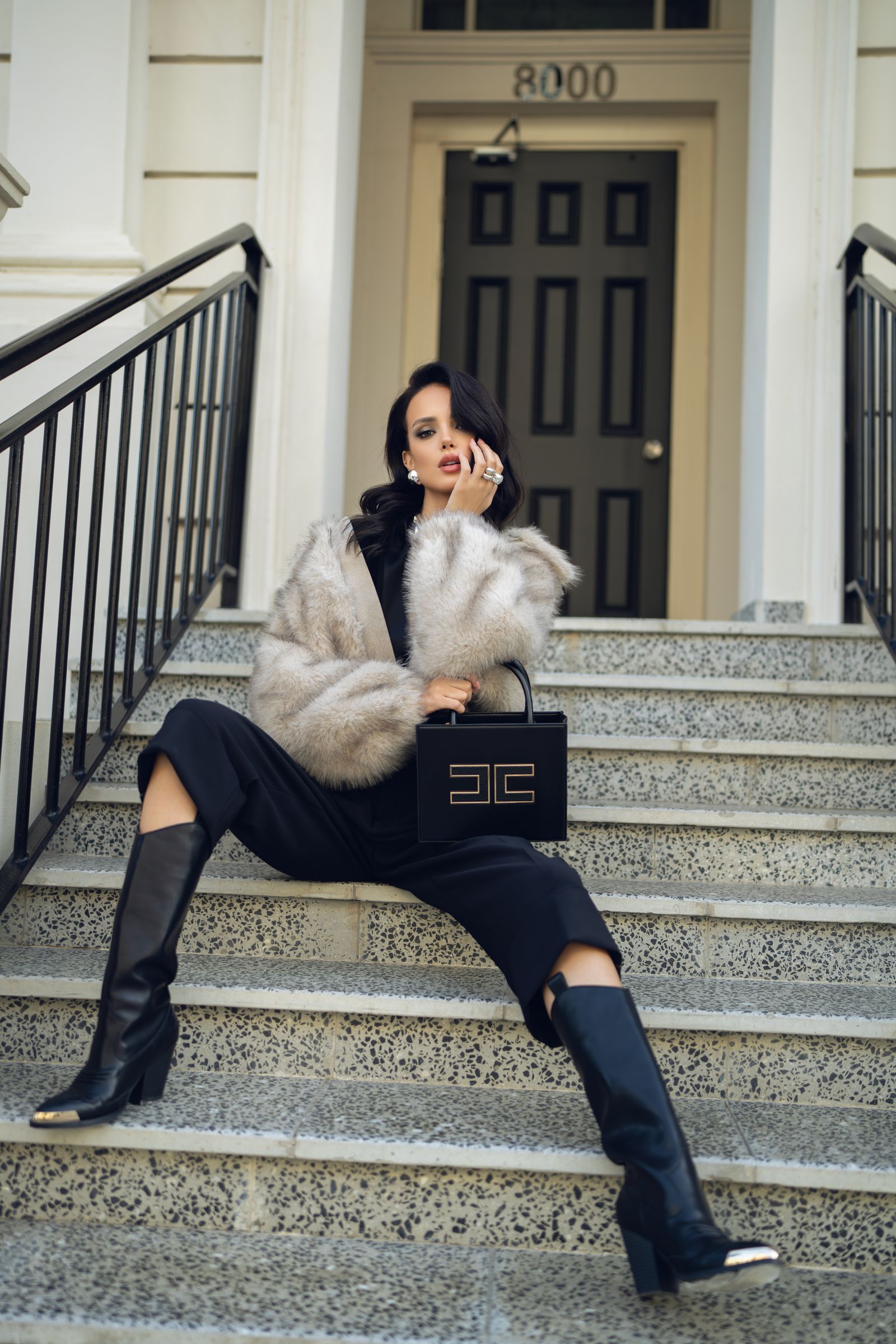 Model in a tailored look on an urban staircase