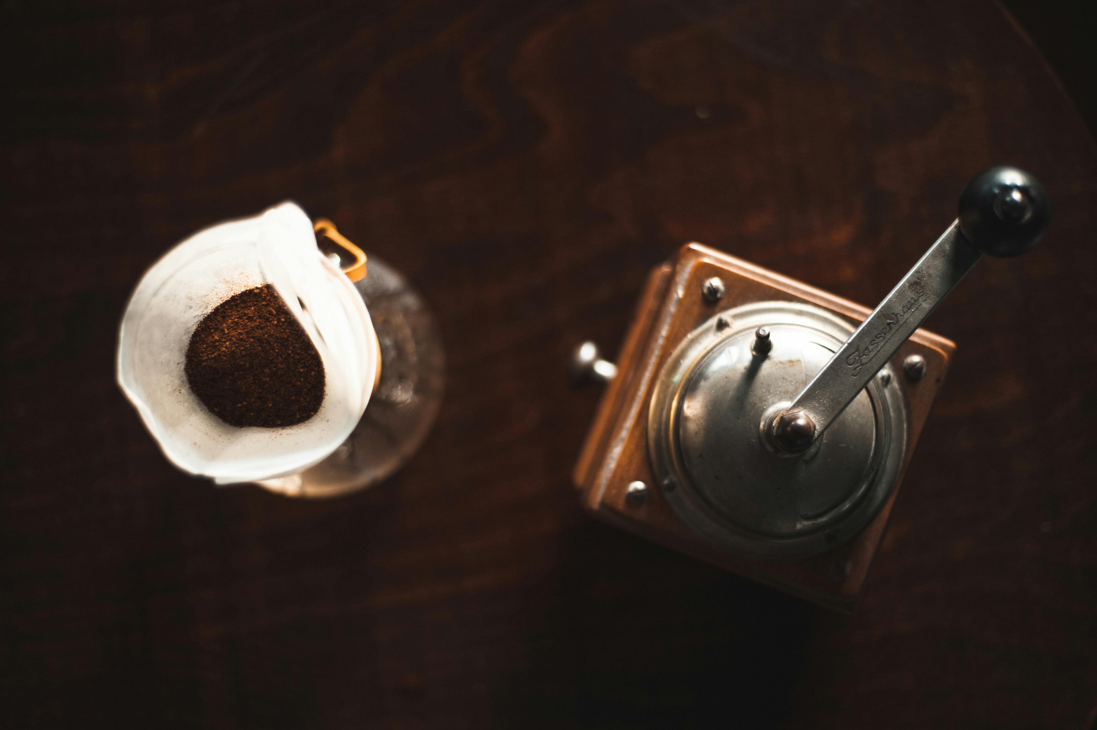 gratis Bovenaanzicht van een vintage koffiemolen naast een filterkoffie-opstelling. Stockfoto