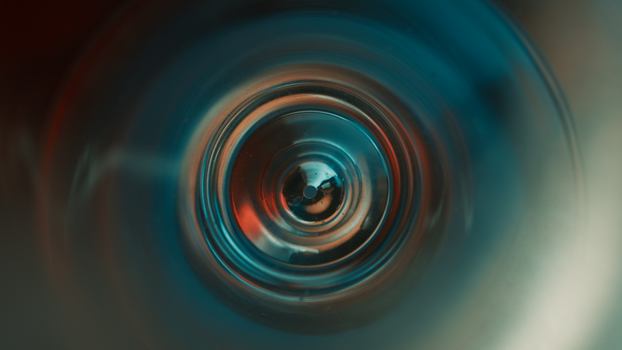 A mystical abstract image featuring a vortex with vivid blue and orange lighting, creating a futuristic and cinematic feel.