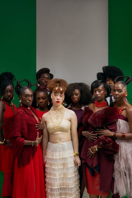 Group fashion portrait showcasing diverse elegance in red tones.