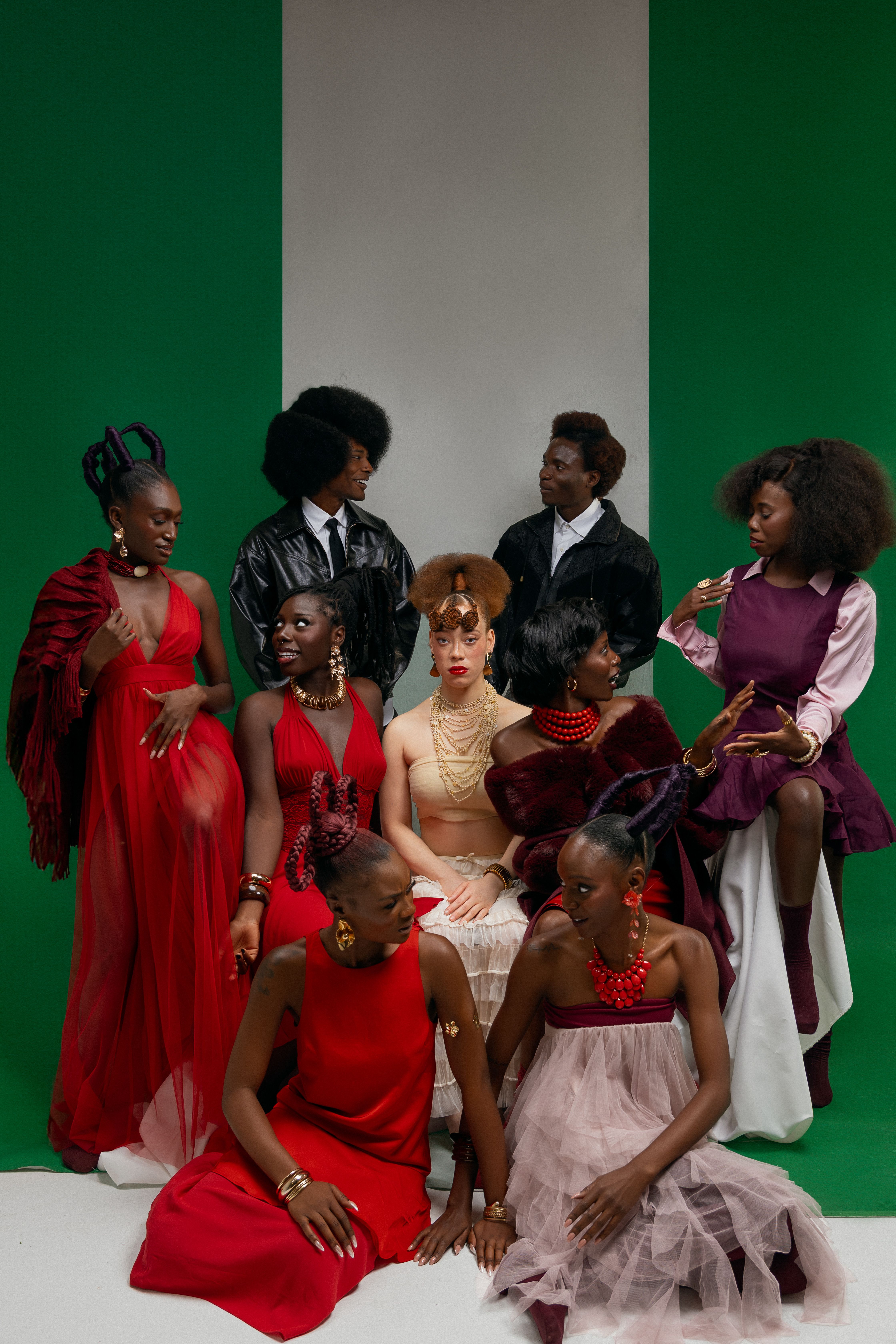 Stylish group posing in elegant fashion with striking backdrop.