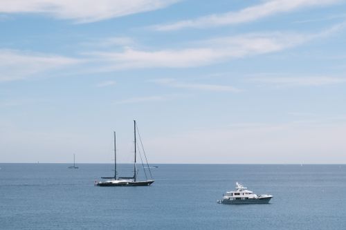 Free Scenic view of yachts sailing in the Mediterranean Sea off the coast of Antibes, France. Stock Photo