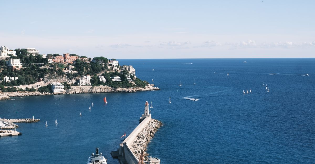 Beautiful seaside view in Nice, France, with yachts and sailboats on a sunny day.