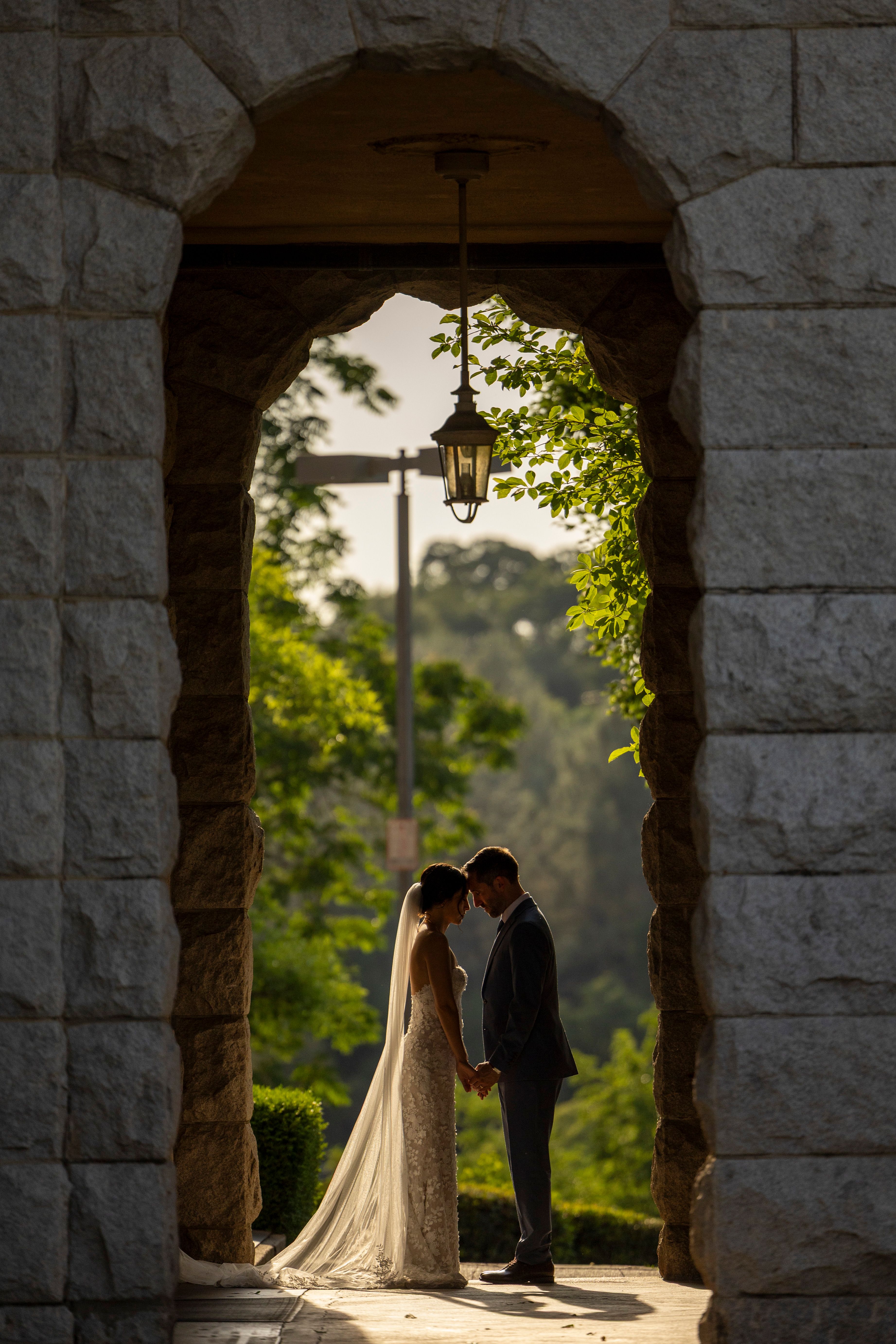 Romantic Wedding Couple Under Stone Archway · Free Stock Photo