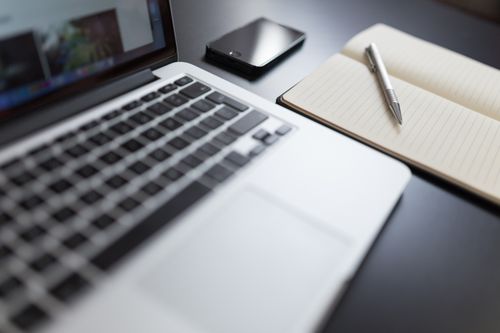 Contracts folder cover: notebook and pen on a desk — Negative Space on Pexels