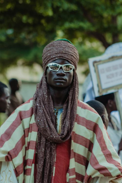 Free A person in traditional attire poses during a vibrant cultural parade. Stock Photo