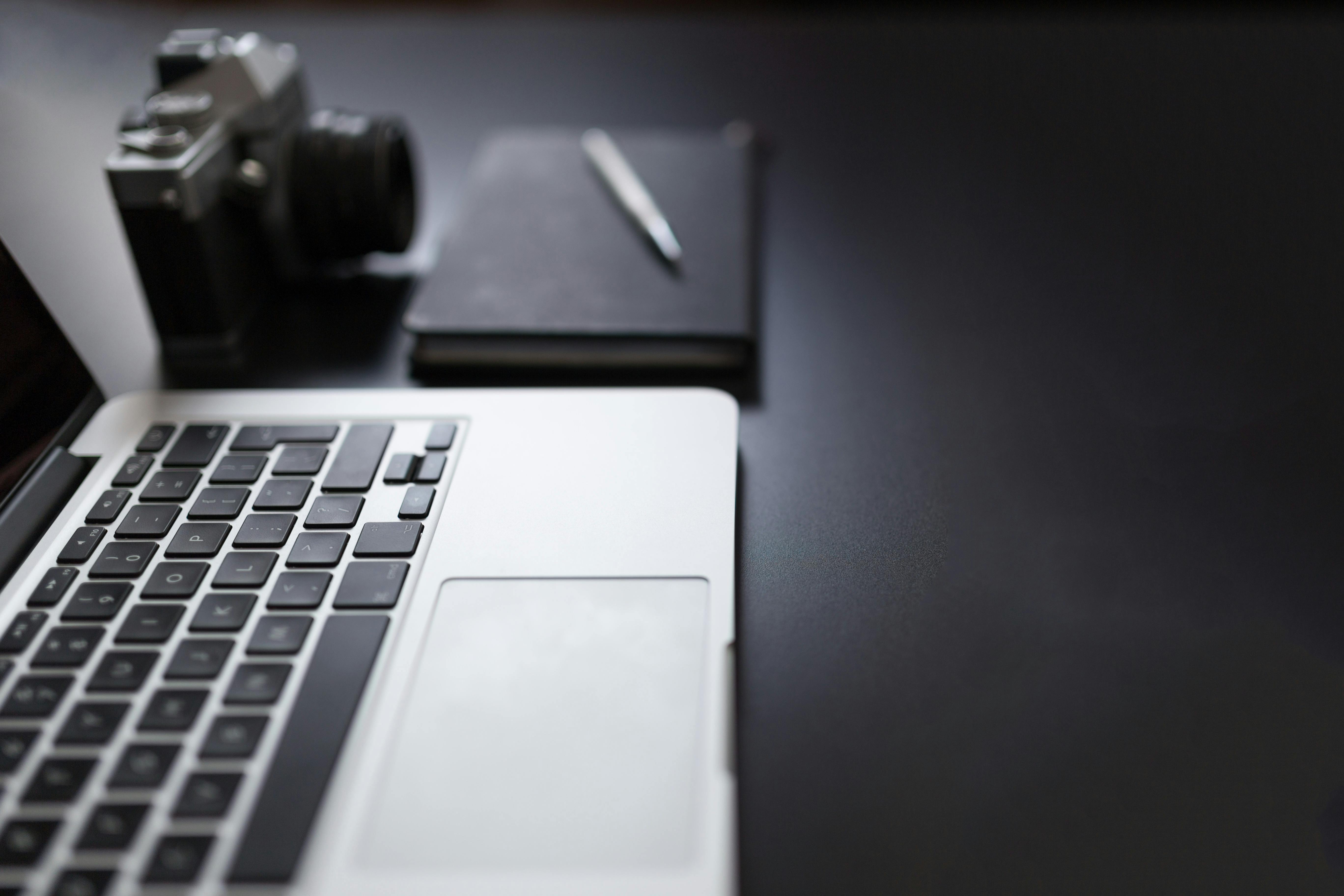 Grayscale Photography of Laptop Computer Beside Book and Camera · Free ...