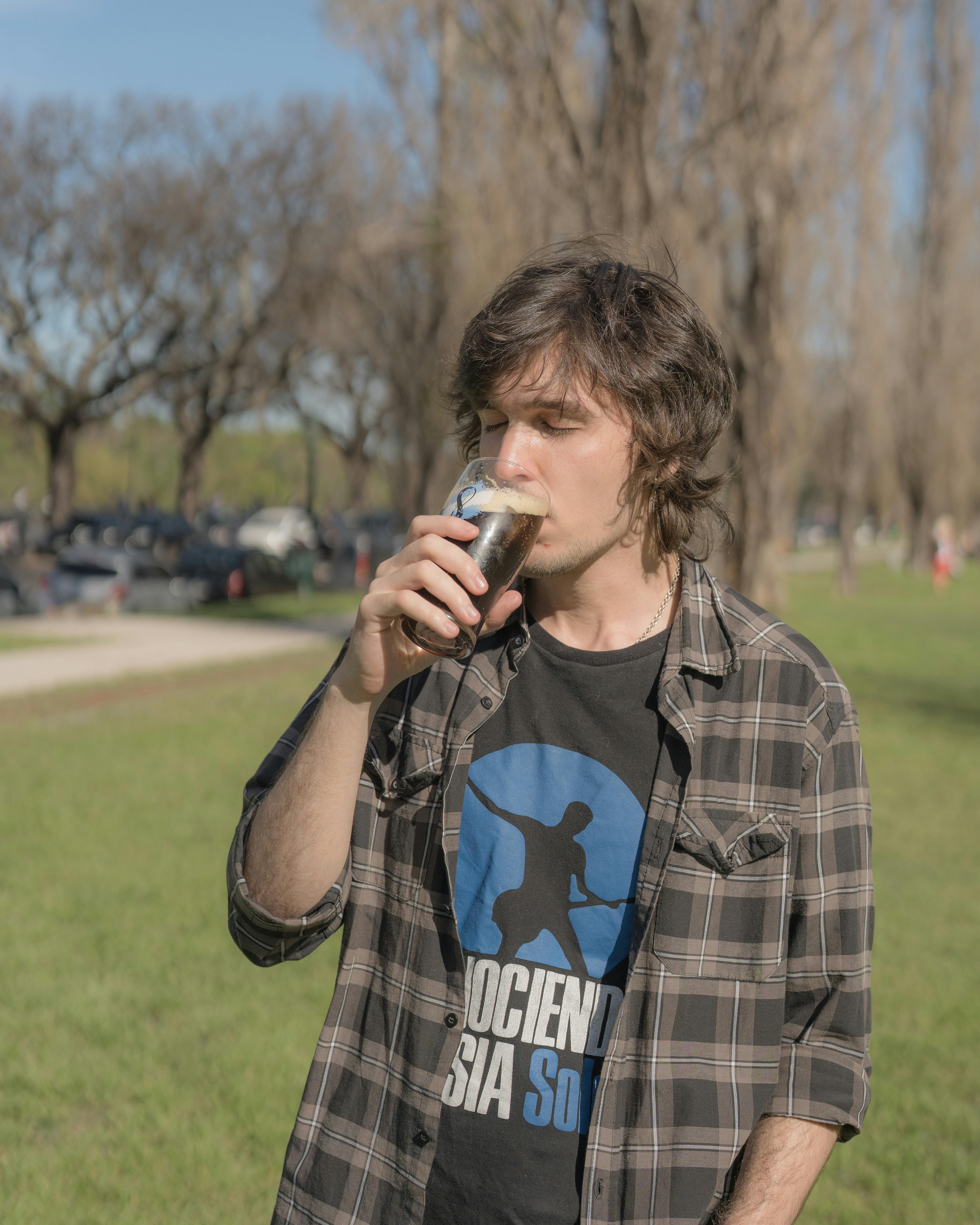Young man enjoying traditional mate beverage in a park in Buenos Aires, Argentina.