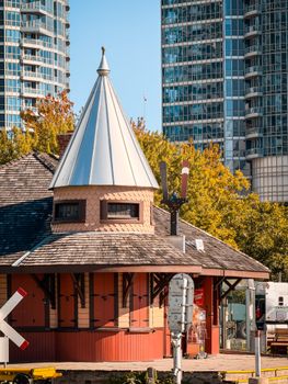 Old train station in Toronto with modern skyscrapers in the background, showcasing contrast.