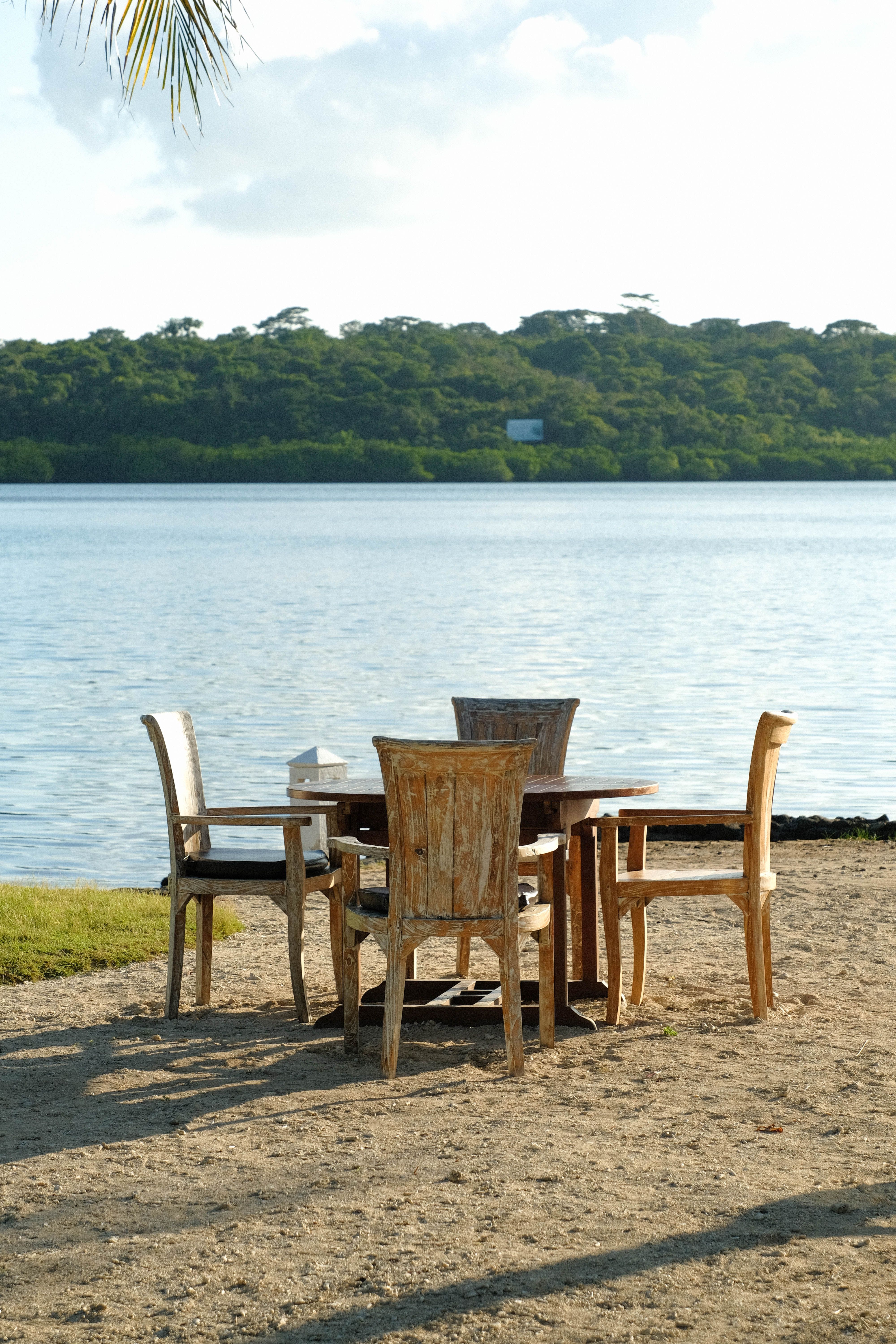 Rustic chairs by scenic Bali waterfront · Free Stock Photo