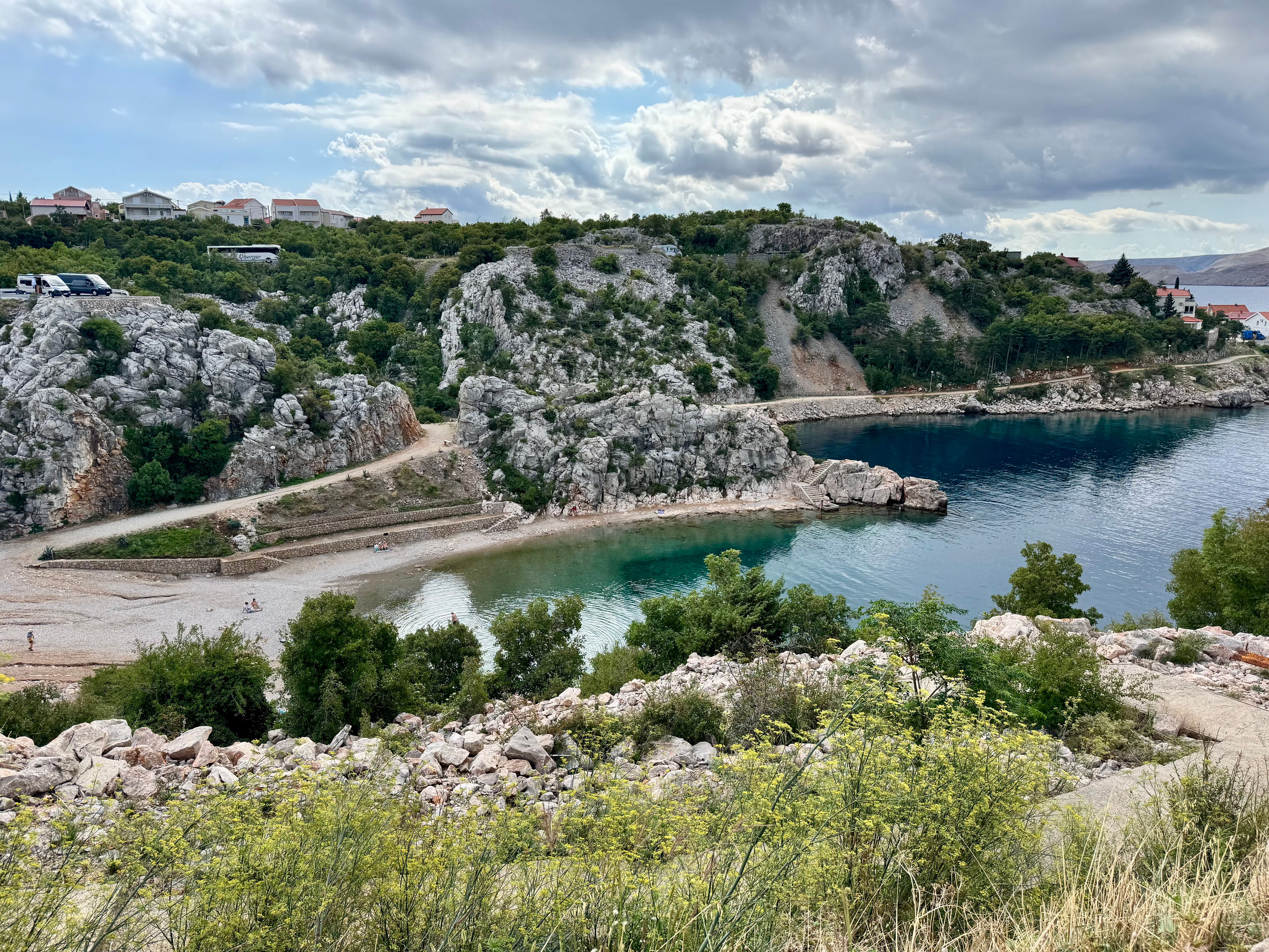 Small pebble beach at Sveti Jakov below cliffs