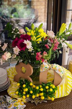 Colorful floral arrangement for a festive 80th birthday with lemons and decorations.