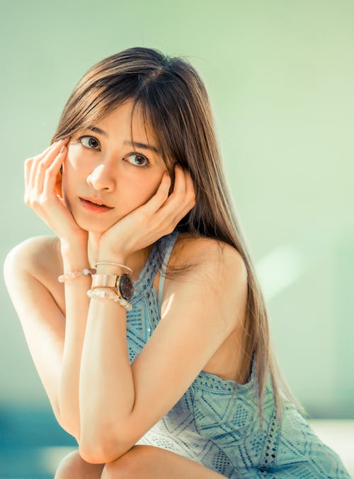 Free Shallow Focus Photo of Woman in Blue Sleeveless Shirt Stock Photo