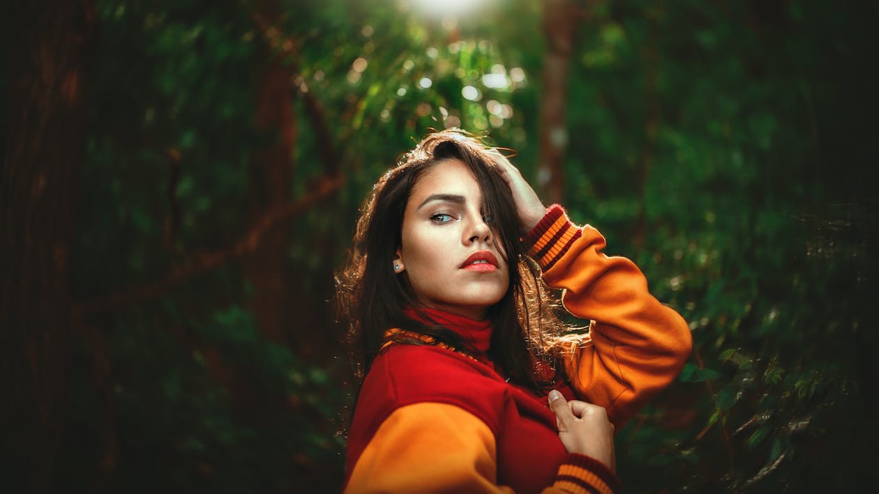 Woman Wearing Red and Orange Letterman's Jacket