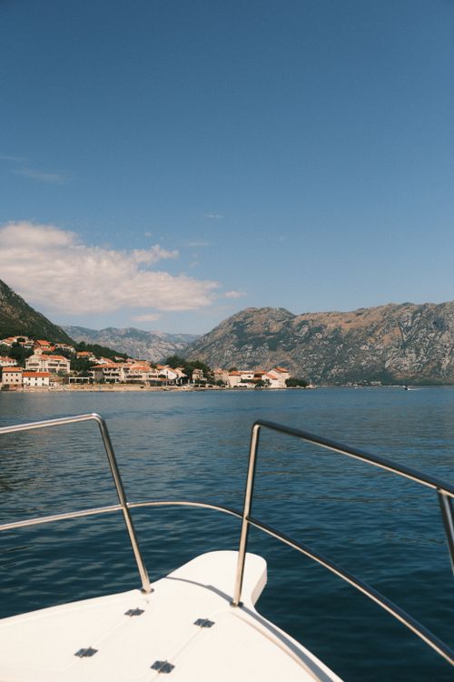 Free A scenic view from a boat of the Bay of Kotor, surrounded by mountains in Montenegro. Stock Photo