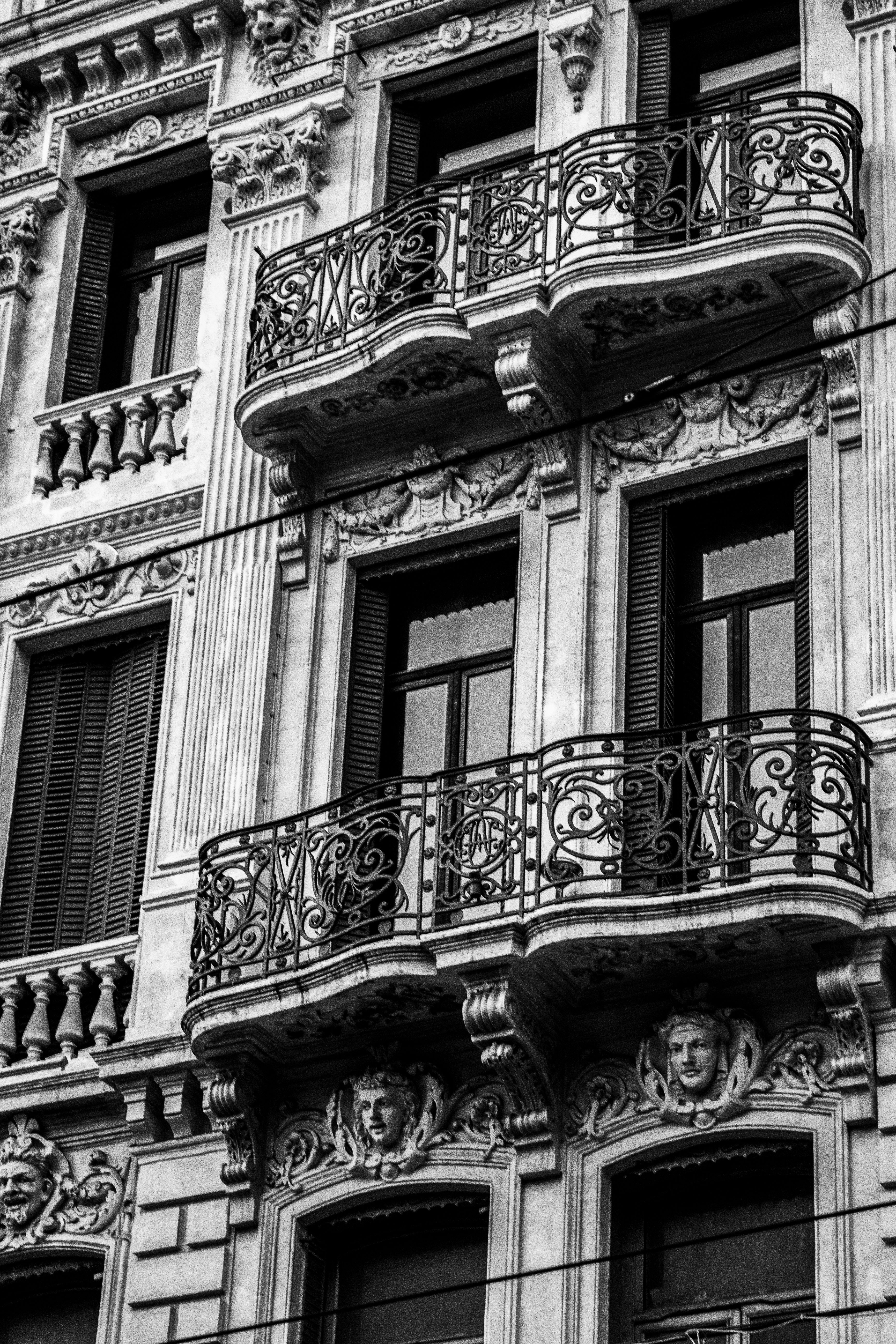 Vintage European Building Facade with Ornate Balconies · Free Stock Photo