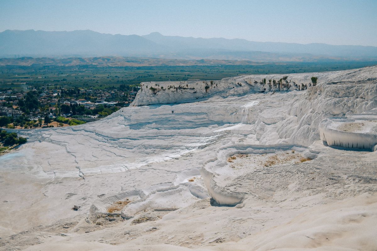 Pamukkale's white calcium terraces — "Cotton Castle," fed by thermal springs above the ancient spa city of Hierapolis.