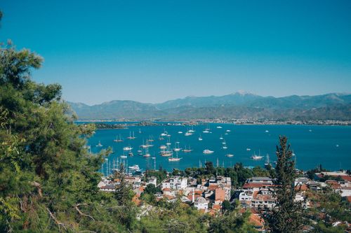 Free A breathtaking view of a coastal town with yachts anchored in the clear blue Mediterranean waters. Stock Photo