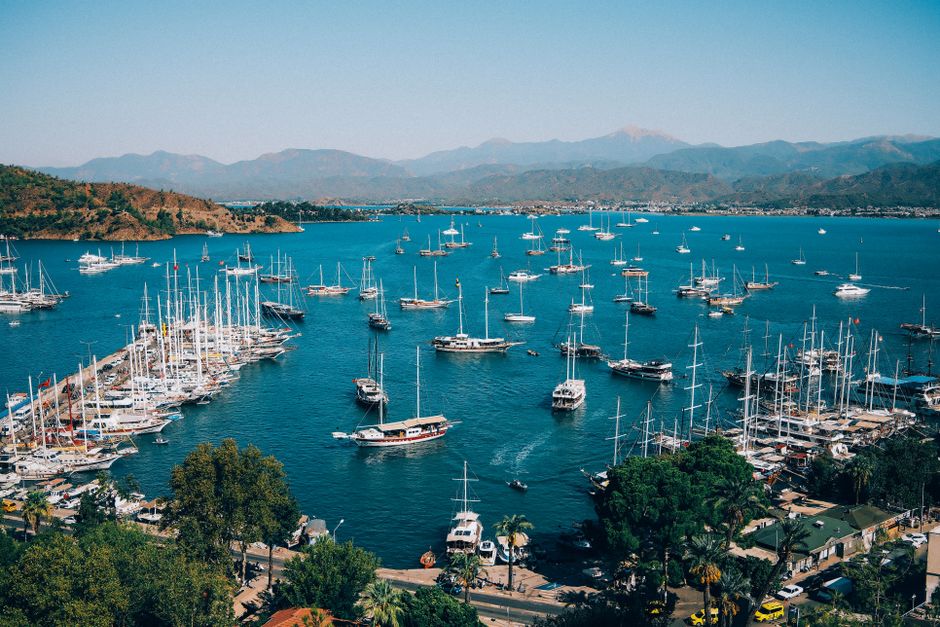 Unbeatable Bodrum Private Motor-Yacht Tour With Lunch For 6 Hours Review 2026 - Explore the vibrant Fethiye Marina with dozens of colorful boats docked against a mountain backdrop.
