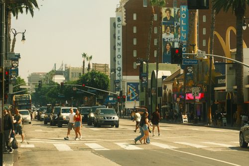 Free Vibrant street view of Hollywood Boulevard with pedestrians and traffic at a crossroads. Stock Photo