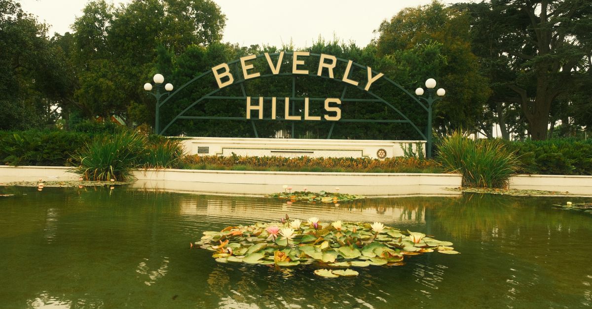 Iconic Beverly Hills sign with serene lily pond, perfect for travel and cityscape themes.